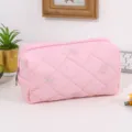 Pink quilted cosmetic bag with cute embroidered bows, portable travel makeup pouch for daily use. - Pink