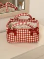 Detail view of red white plaid quilted storage basket with sweet bow knots and floral interior. - Small Storage Basket / Red Gingham (Vermillion)