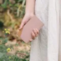 Detailed view of the minimalist slim leather card holder in pink and brown, perfect for daily use. - Pink