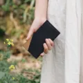Minimalist black and brown leather wallet and card holder detail view outdoors natural style - Black