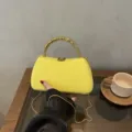 Detail view of yellow PU hard box evening clutch bag with unique gold beaded handle and chain. - Box Bag / Yellow