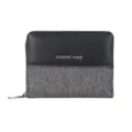 Detailed view of the short bifold wallet featuring black leather and grey denim patchwork design. - Black