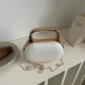 Elegant white acrylic evening bag with luxury gold top handle and chic chain strap for women. - White