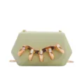 Close-up detail of green acrylic clutch bag with luxury gold finger hardware and rhinestones. - Light Green