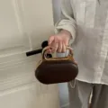 Dark brown oval evening bag with gold metal handle and chain strap, elegant women crossbody handbag - Brown