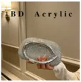 Close-up view of stunning rhinestone acrylic evening clutch bag featuring metal ring handle. - Silver