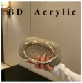 Rhinestone evening clutch bag detail view, sparkling crystals with metallic ring handle. - Gold