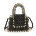 Close-up of handmade black and silver beaded mini handbag with top handle and strap. - L / Black
