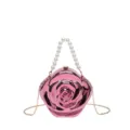 Detailed closeup view of the pink rose-shaped acrylic evening clutch with pearl handle. - Pink Top-Handle Crossbody Bag