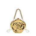 Gold rose acrylic evening bag detail, glossy finish texture, metal chain strap close up view. - Top-Handle Crossbody Gold