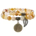 Close-up detail of double layer natural stone beaded bracelet with antique bronze charm. - 13