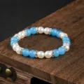 Bracciale di perle blu e bianco alla moda con cristalli luminosi per le donne eleganti. - Cristallo Blu Falsa Perla