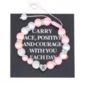 Handmade braided pink pearl bracelet with stainless steel initial heart charm detail view. - Letter X
