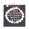 Close up detail of handmade pink pearl beaded bracelet with stainless steel letter R charm. - Letter R