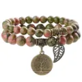 Close-up view of natural unakite stone double-layer beaded bracelet with vintage bronze tree charm. - Unakite