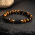 Detailed shot of tiger eye and black tourmaline beaded bracelet with golden metal spacers. - 6mm Beads / Tiger's Eye and Black Tourmaline