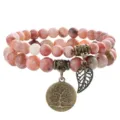 Close up detail of double layer natural stone beaded bracelet with bronze tree of life charm. - 12