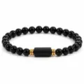 Detailed view of black obsidian beaded bracelet with elegant gold spacers and central cylinder. - Black Glass and Black Tourmaline