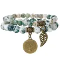 Natural stone beaded bracelet detail with antique bronze tree of life charm and leaf pendant. - 06