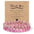 Detail view of double layer pink gemstone beaded bracelets elegantly displayed on a kraft card. - Red Wood Grain Stone & Pink Cat's Eye