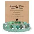 Detailed shot of green gemstone beaded bracelets with appreciation card, elegant and natural. - 4mm / Green Striped Agate & Green Aventurine
