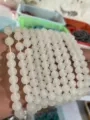 Close-up detail of white gemstone round beads strands, ideal for DIY handmade jewelry making. - 4mm Bead Bracelets / White Jade