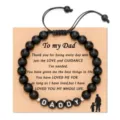Close-up detail of the black beaded dad bracelet with kraft card and custom letter beads. - 8mm Black Stone DADDY