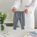 Gedetailleerd overzicht van grijze peutermeisjes leggings met delicate witte kantafwerking. - 73cm / Grijs