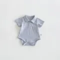Close-up detail of the grey baby polo romper featuring a cute puppy embroidery and soft fabric. - 66cm / Gray