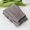 Detailed close up view of children ribbed knit tights neatly folded with tulip decor. - S / Khaki