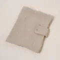Detail shot of the cotton gauze notebook sleeve with snap button in beige, fine texture. - Khaki