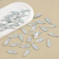Detailed view of iridescent navette rhinestones, flatback opal cabochons for DIY crafts. - 100 Pieces/Pack / White AB