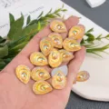 Detailed shot of 18x24mm teardrop resin rhinestones with AB colorful flatback design. - Teardrop Flatback Rhinestone / 18x24mm (25 Pieces/Pack) / Golden Yellow AB