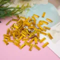 Detailed close-up shot of sparkling yellow rectangular sew-on rhinestones with mounting holes. - Long Flat Plated Bottom / 100 Pieces Pack (6x17mm) / Golden