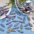 Detail shot of iridescent marquise flatback rhinestones for DIY crafts and nail art. - 100 Pieces/Pack / Big Red AB