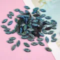 Close-up of blue green iridescent resin horse eye rhinestones for DIY handmade craft 7x15mm - Black AB