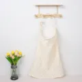 Close-up detail of cotton nursing cover with colorful dots hung on wooden wall rack. - Colorful Polka Dots with Wooden Ring