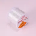 Primer plano detallado del rollo de hilo de cristal elástico transparente de 0.7mm. - 0.7mm / Transparente