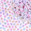 Colorful dash patterned white round craft beads for DIY handmade bracelets and necklaces. - Letter I