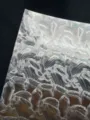 Detailed shot of silver holographic double flash badge backing paper texture 128g - Shell Texture