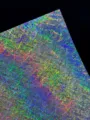 Close-up detail of holographic specialty cardstock with vibrant rainbow broken glass pattern. - Random Lines