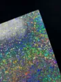 Close-up detail of 128g holographic cardstock with stunning double flash pixel laser pattern. - Mosaic