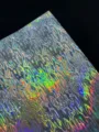 Detailed close-up shot of holographic cardstock with water ripple texture, shiny special paper. - Water Wave