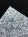 Detailed close-up of glossy porcelain specialty paper with double-flash texture for crafts. - White Porcelain Style