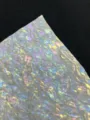 Close-up detail view of colorful silk series holographic specialty paper texture for badge making. - Landscape Reflections Style