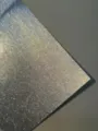 Detailed close-up of colorful glitter flash specialty paper, showing fine sand texture. - Silver