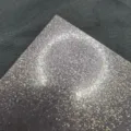 Fine glitter paper detail close-up showing 130g mirror sparkle specialty paper texture and surface. - Silver