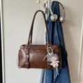 Sac à épaule marron vintage de grande capacité avec boucles métalliques et joli pendentif poupée. - Avec Pendentif / Marron
