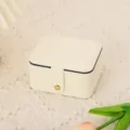 Detail view of portable leather jewelry storage box in cream white color, compact design. - 10.7*9*6 / White Double-Layer Square Mirror Jewelry Box