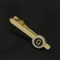 Gold-tone metal tie clip featuring a stylish black round inlay with crystal rhinestones and letter G. - T1051-G Tie Clip